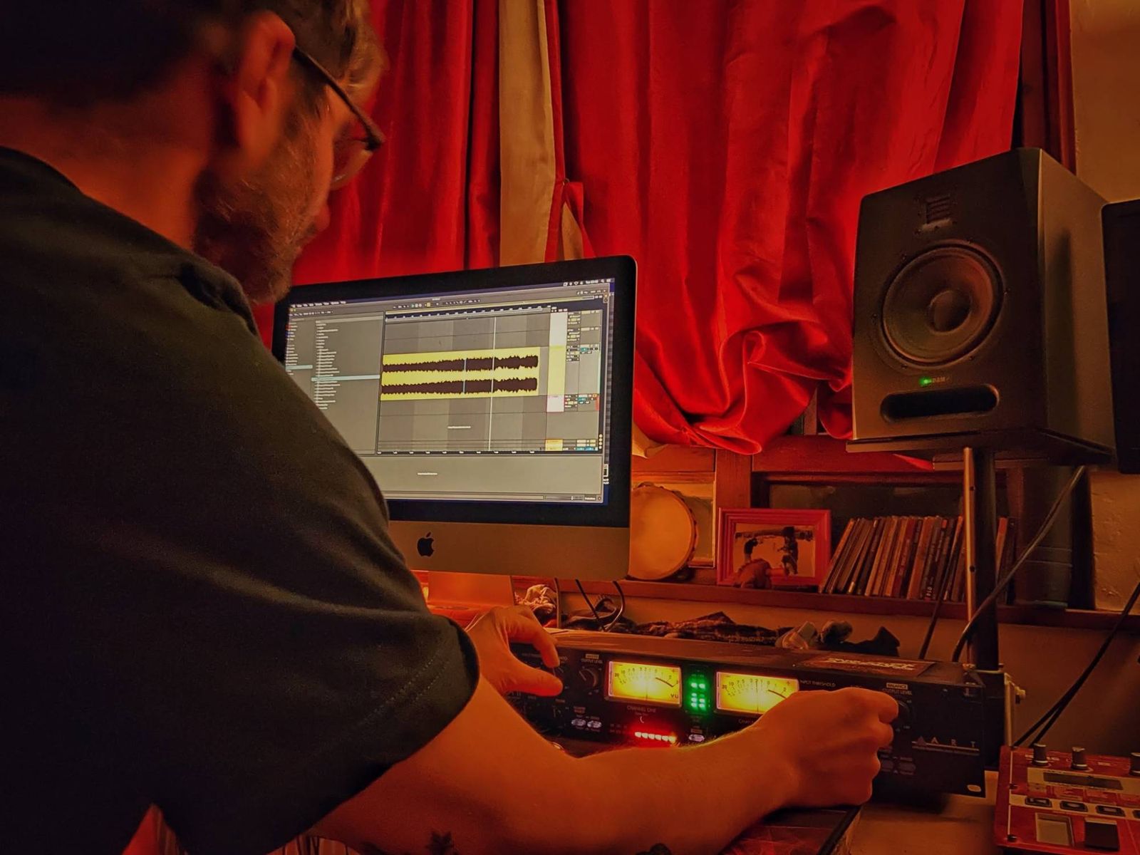 Working at the Siriustudio desk: Ableton Live on screen, hands on the valve compressor's controls, studio monitor alongside